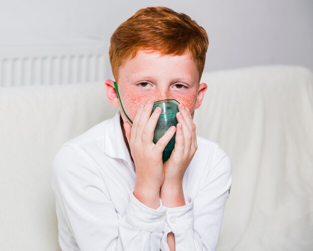 Vooraanzichtjongen met zuurstofmasker