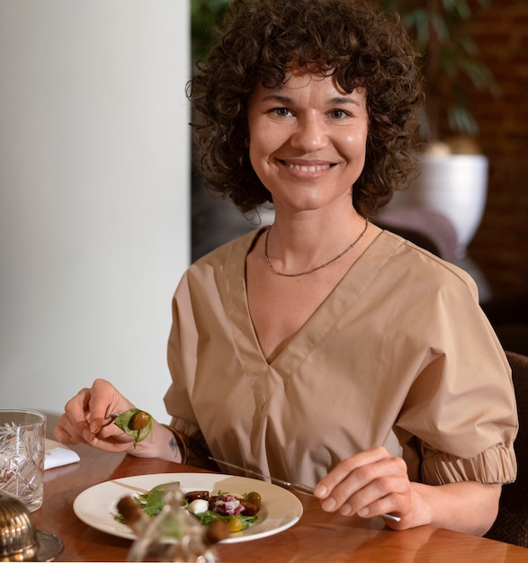 Vooraanzichtvrouw die lunch hebben bij restaurant