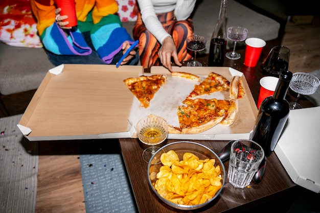 Gratis foto vrienden op een feestje met heerlijke pizza.