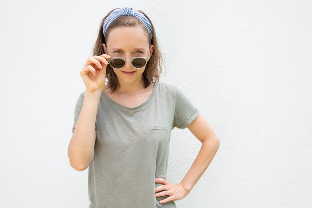 Vrolijke jonge vrouw die haarband en de zomerkleren draagt