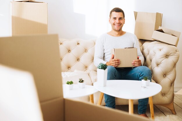 Vrolijke man in appartement met vakken