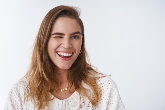 vrouw 25s kort kastanjebruin haar knipogend vrolijk glimlachend brede witte tanden, plezier genietend van de lente positieve vibes