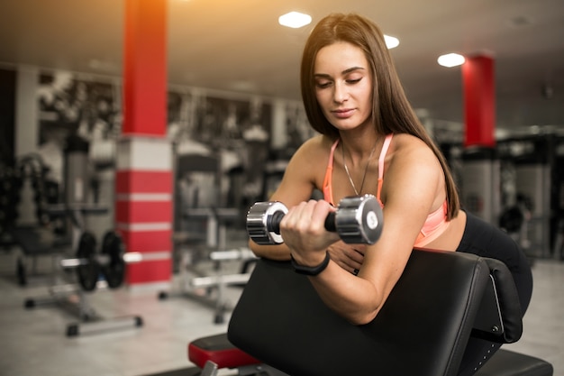 Vrouw bij de gymnastieklichaamsbouw