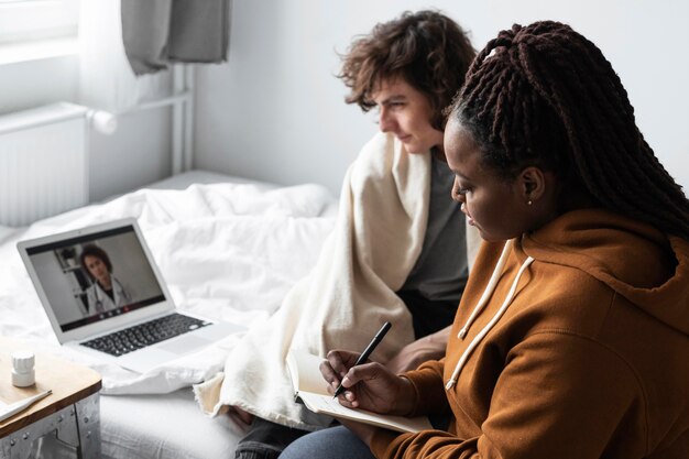 Vrouw die aantekeningen maakt van de arts van haar vriend