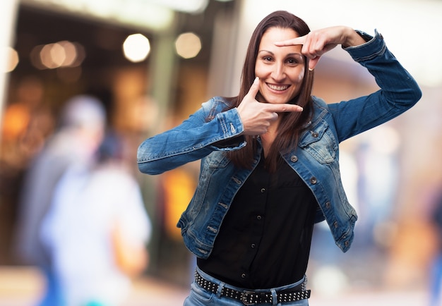 Vrouw die een frame met haar vingers