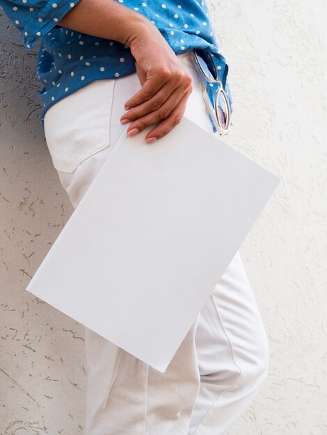 Vrouw die een modeltijdschrift houdt