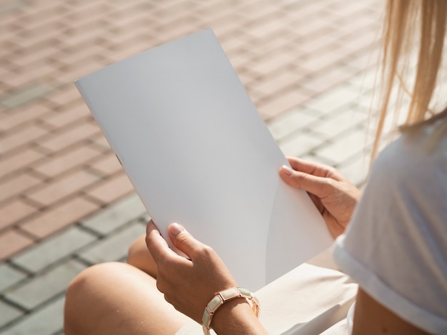 Vrouw die een modeltijdschrift houdt