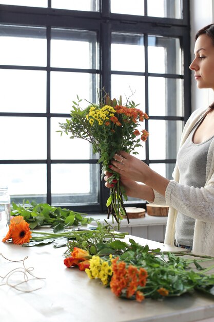 Vrouw die een mooi bloemenboeket maakt