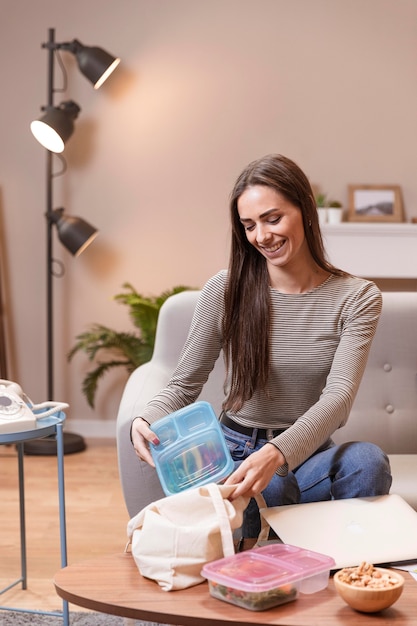 Vrouw die een onderbreking van het werk neemt en zich klaarmaakt om te eten