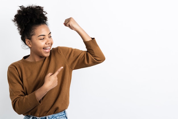 Gratis foto vrouw die en aan spier stelt richt