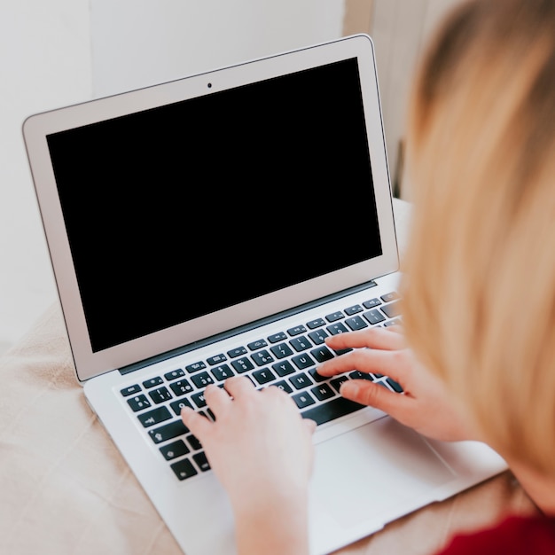 Gratis foto vrouw die laptop op bed met behulp van