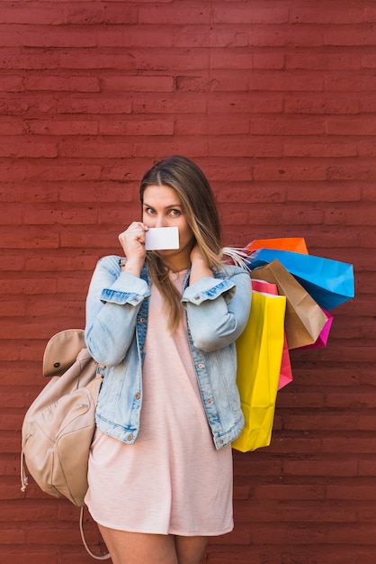 Gratis foto vrouw die mond behandelt met creditcard