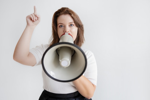 Vrouw die wijsvinger opheffen wanneer het spreken luid in megafoon