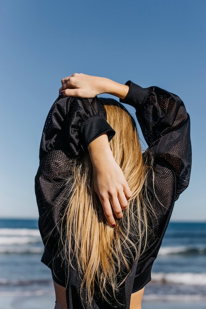 Gratis foto vrouw die zich uitstrekt op het strand