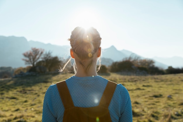 Vrouw die zon in aard onder ogen ziet