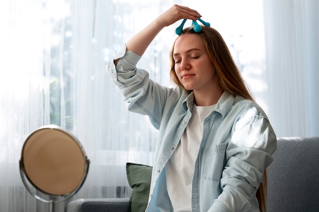 Vrouw geeft zichzelf een scalp massage.