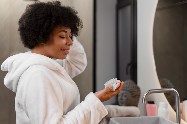 Gratis foto vrouw geeft zichzelf een scalp massage.