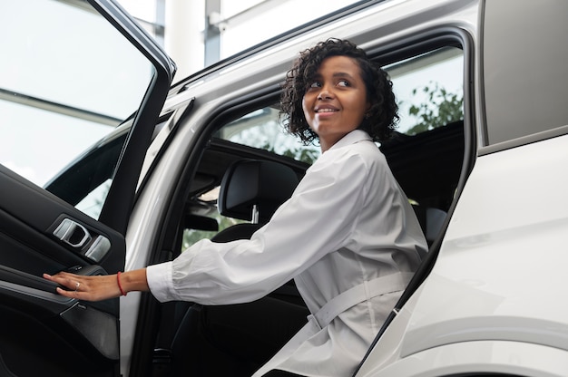 Vrouw geniet van haar financiële onafhankelijkheid terwijl ze een auto koopt