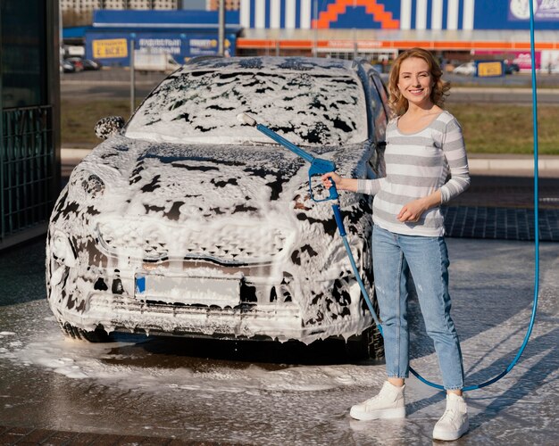 Vrouw haar auto buiten wassen