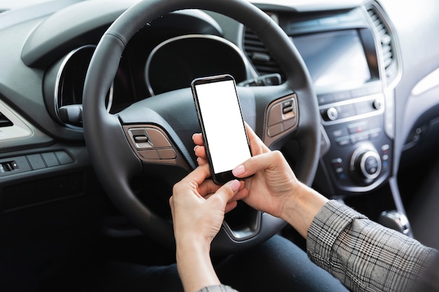 Vrouw in de telefoonmodel van de autoholding