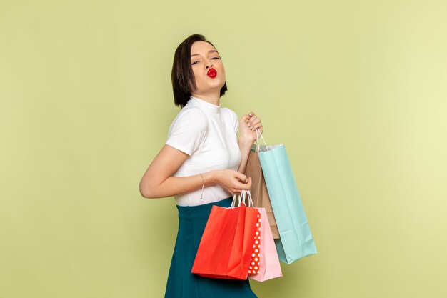 vrouw in witte blouse en groene rok shopping pakketten te houden