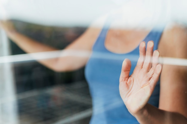 Vrouw kijkt door het raam tijdens quarantaine