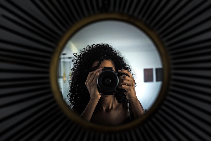 Gratis Foto vrouw met camera die beeld van bezinning neemt
