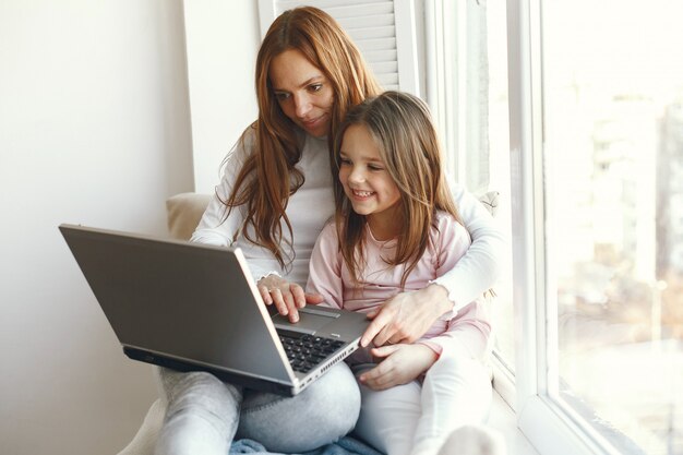 Vrouw met dochter die laptop computer met behulp van