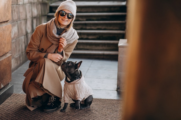 Vrouw met haar huisdieren Franse buldog die weggaat