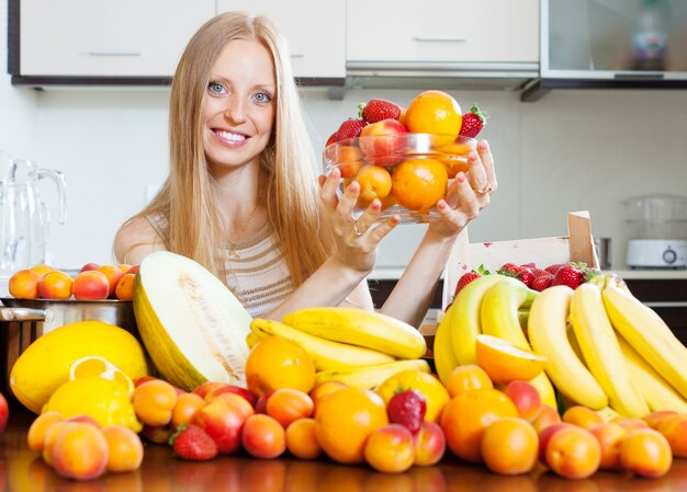 vrouw met hoop van verschillende vruchten