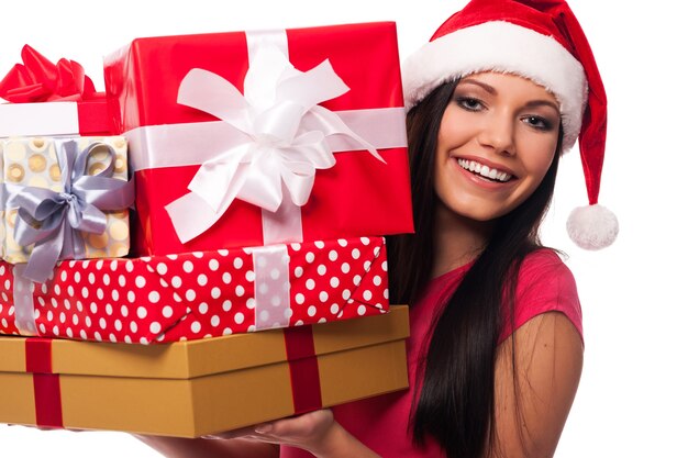 Vrouw met kerstmuts met stapel kerstcadeaus