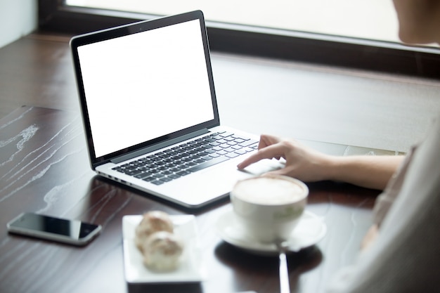 Vrouw met laptop op een houten tafel