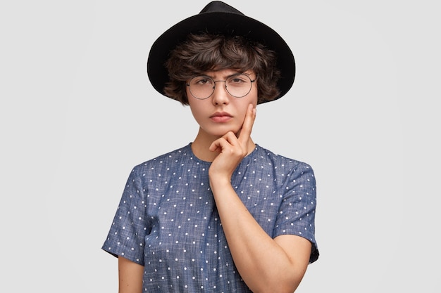Vrouw met polka dot blouse en grote hoed