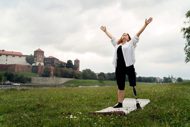 Vrouw met prothetisch been die yoga doet