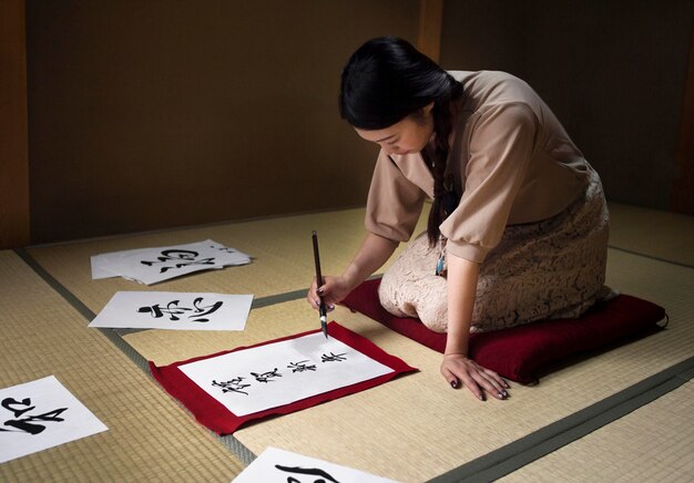 Vrouw oefent Japans handschrift binnenshuis
