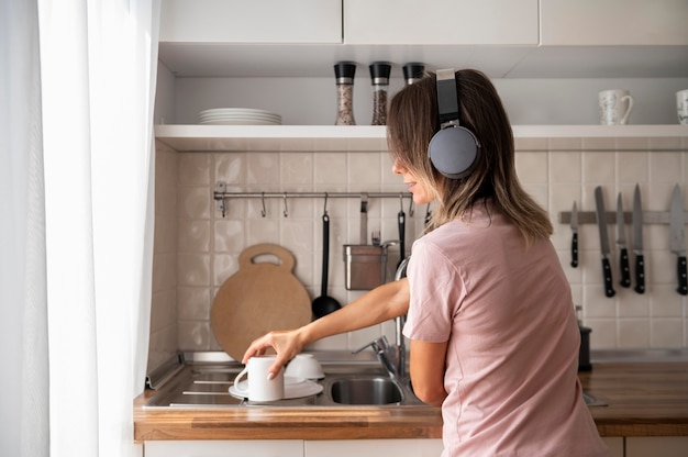 Vrouw ontspannen thuis tijdens het luisteren naar muziek