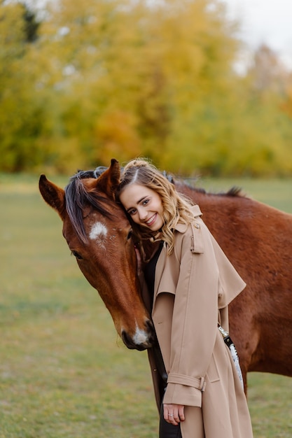 Vrouw op een paard bij rancho. Paardrijden, hobbytijd. Concept van dieren en mensen