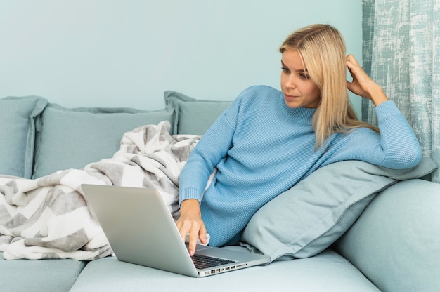 Vrouw tijdens de pandemie die aan laptop thuis werkt