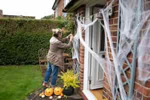 Gratis foto vrouw versiert haar huis voor halloween