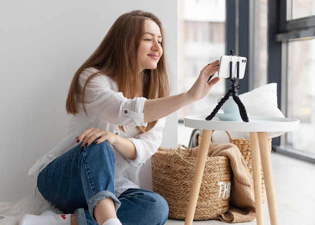 Gratis foto vrouw vloggen met haar telefoon