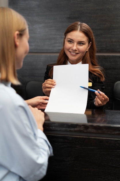 Gratis foto vrouwelijke receptioniste in elegant pak tijdens werkuren