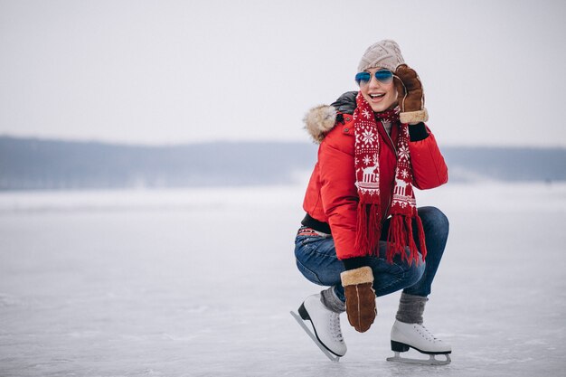 Vrouwenijs die bij het meer schaatsen