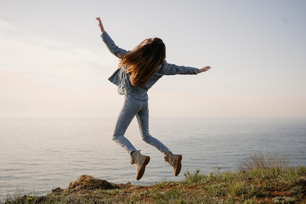 Wanderlust concept met jonge vrouw die geniet van de natuur om haar heen