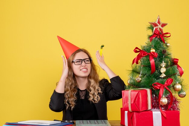 werkneemster die achter haar werkplek op geel zit