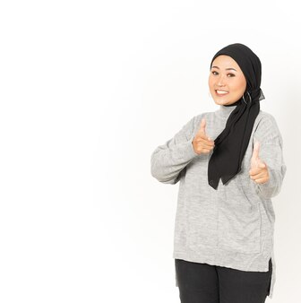 Wijzend naar jou en glimlach van mooie aziatische vrouw die hijab draagt, geïsoleerd op een witte achtergrond