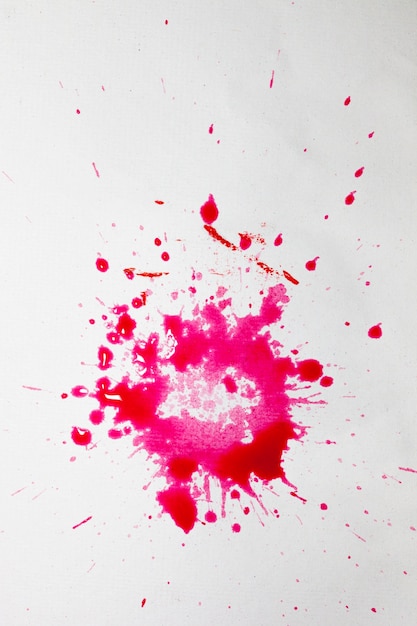 Wit oppervlak met spatten van roze aquarel