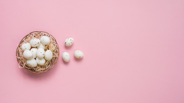 Witte eieren in nest op tafel