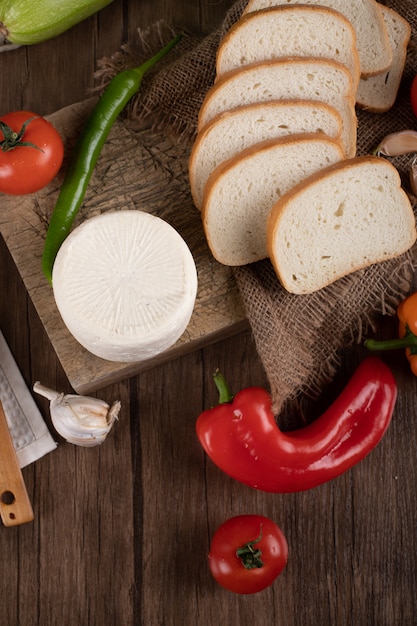 Witte ronde kaas en gesneden brood. Bovenaanzicht