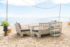 Gratis foto witte stoelen en tafel op het strand