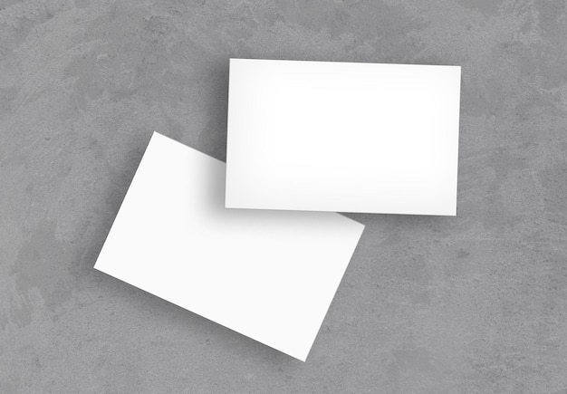 Gratis foto witte visitekaartjes op een betonnen oppervlak